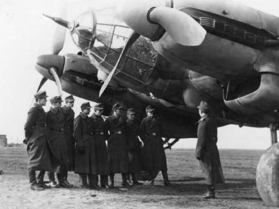 group of soldiers next to a He 111 H