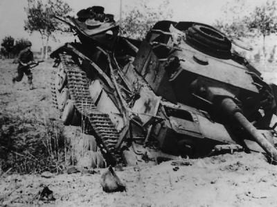 American soldier approaches a knocked out German Panzer IV tank near Salerno