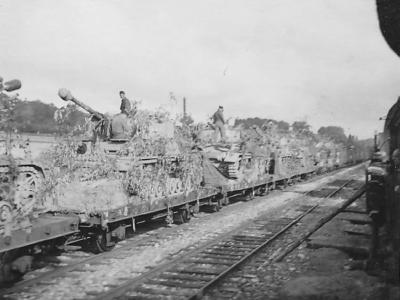 Panzer IV of schwere Panzer Abteilung 503 are loaded aboard flatcars for transport to the front. France Bievres 1944