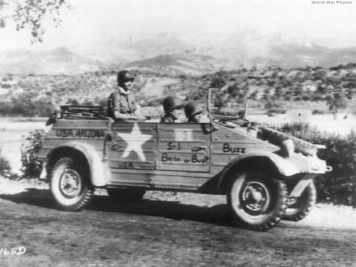 U.S. troops riding in a Volkswagen captured in Sicily