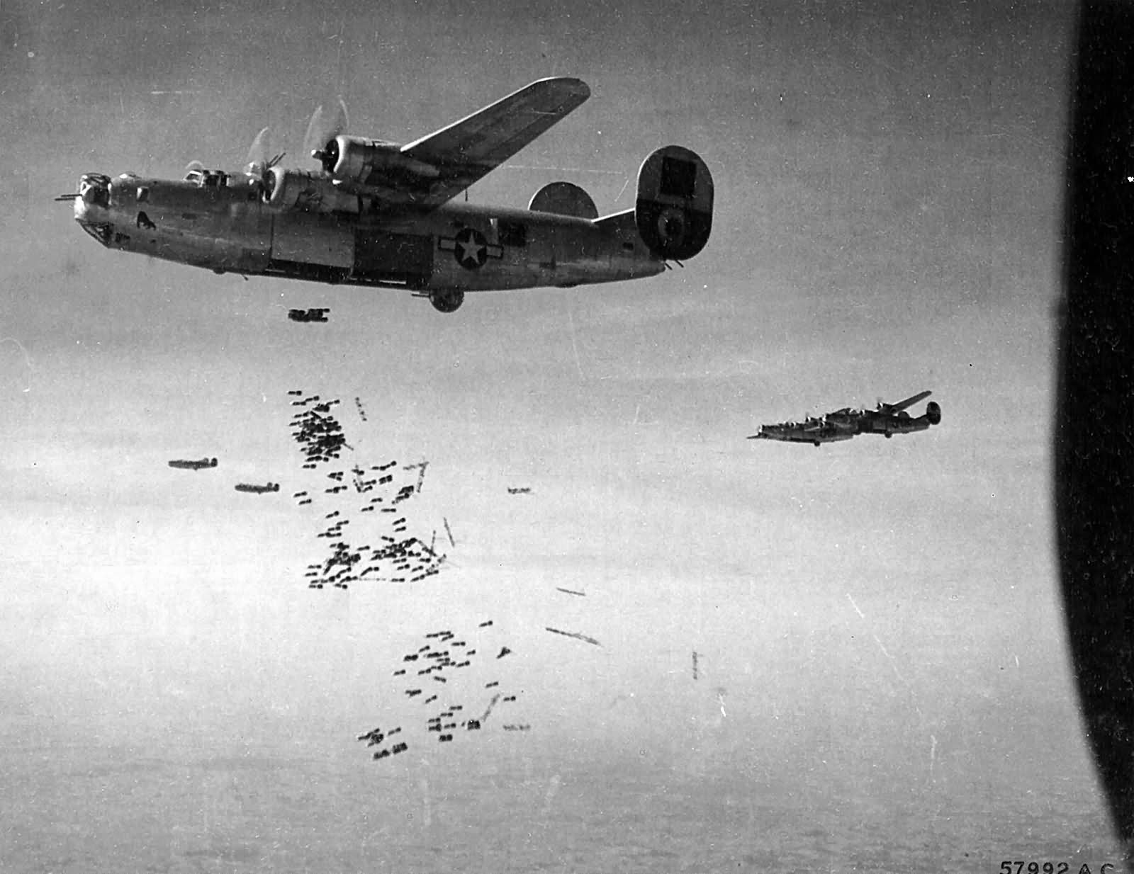 B-24_drops_a_load_of_fragmentation_bombs_on_the_Aidrome_at_Neuberg_Austria_26_March_1945.460th_BG.jpg