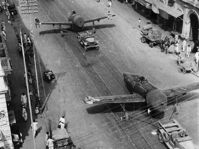Jeeps Tow P-47 Thunderbolts thru streets of Karachi India 1944