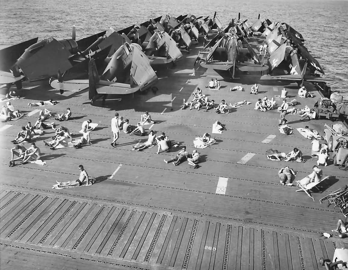 sailors sunbathing on flight deck of uss uss enterprise cv