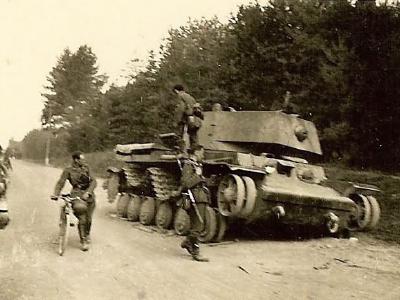 Wehrmacht troops examining russian KV 1 tank on road