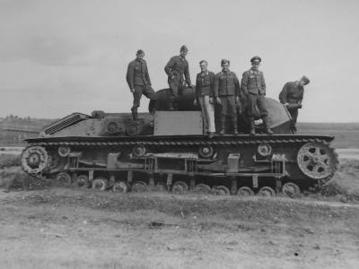German troops pose next to a captured and damaged T-28