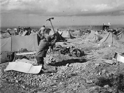 Barrage balloons overhead as US Medics dig in on D-Day beach