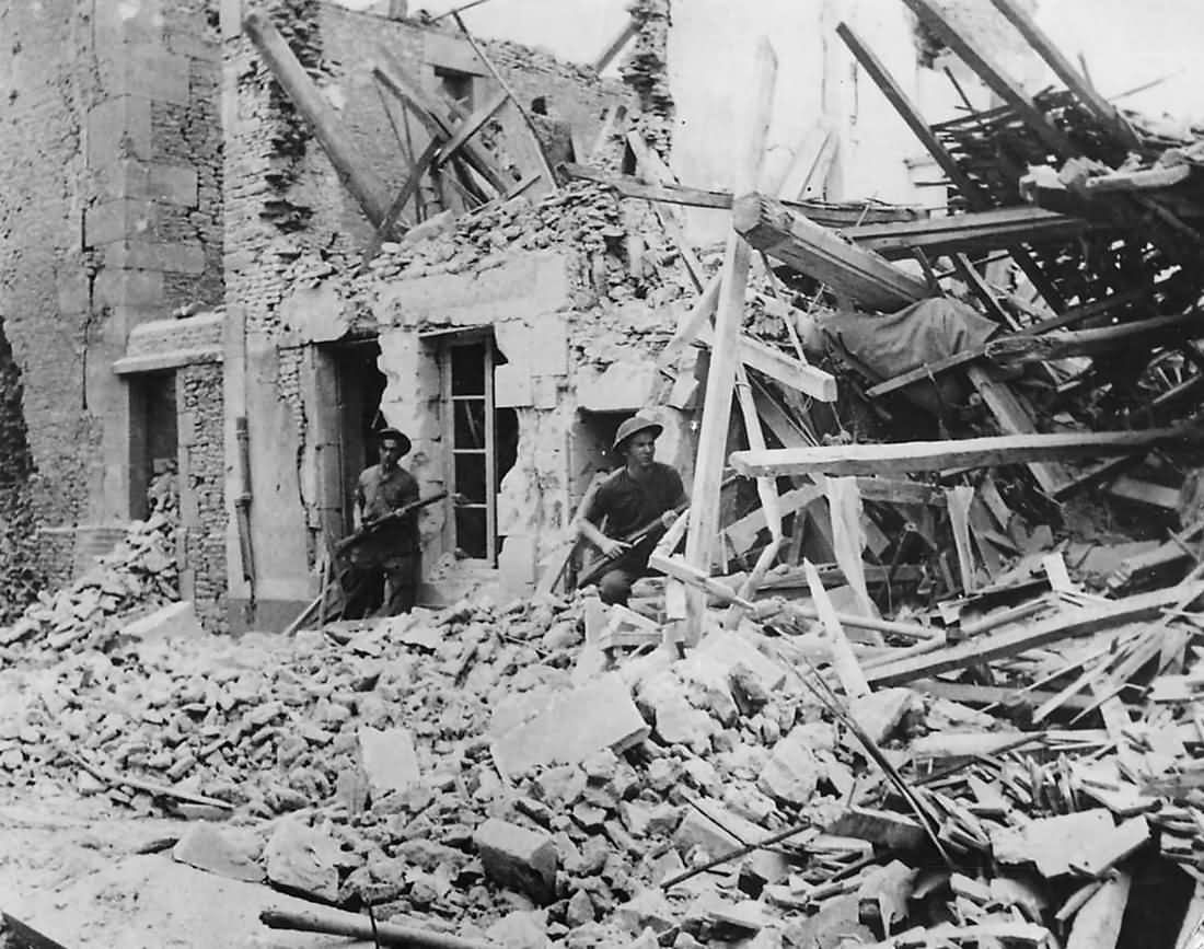 British Troops Advance through Ruins of Demeuville Normandy 1944