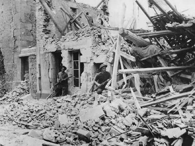 British Troops Advance through Ruins of Demeuville Normandy 1944