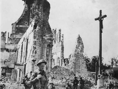 British soldiers pass ruins of St. Desir Church in Lisieux Normandy