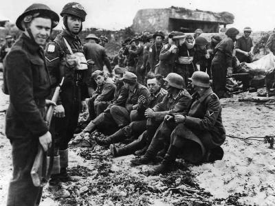 Canadian troops guard German POW on D-Days Juno Beach
