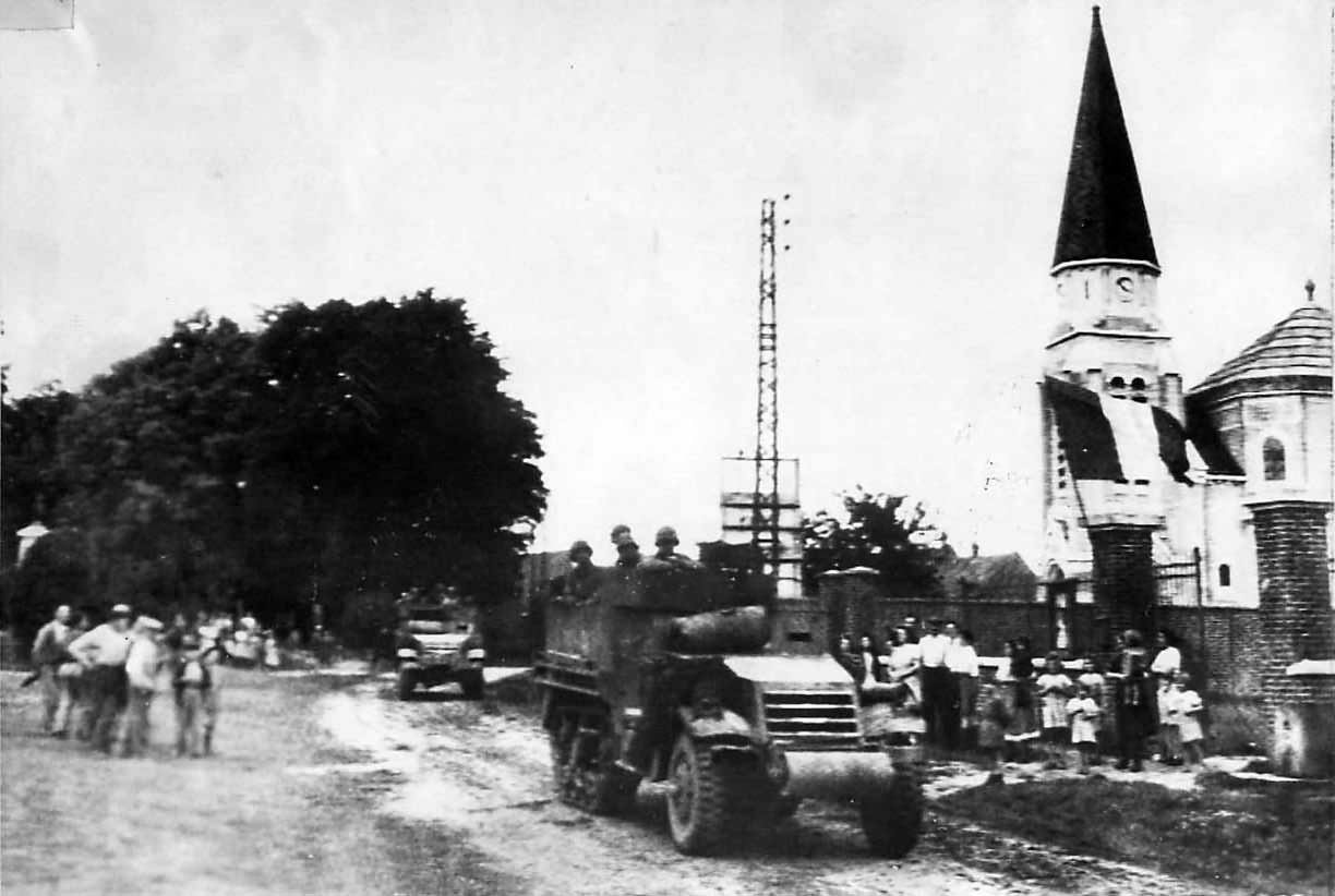 Civilians greet US troops moving thru Cantigny in M3A1