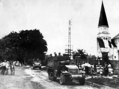 Civilians greet US troops moving thru Cantigny in M3A1