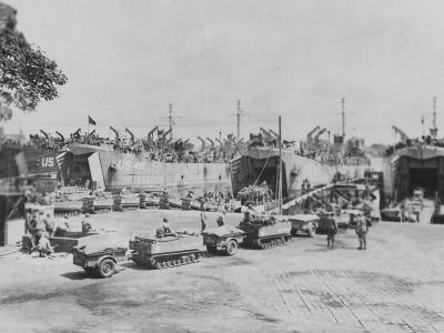 LSTs loading tracked vehicles carts for D-Day assault in England