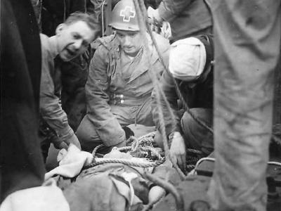Medics transferring wounded soldier from D-Day beachhead