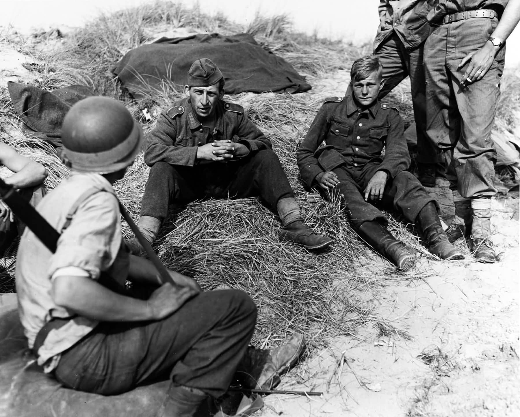 Polish prisoner in German uniform is interrogated by US soldiers 15 June 1944