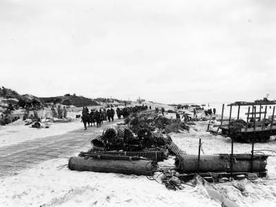 Scene on Utah Beach with troops marching up the road 9 June 1944