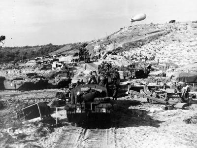 US Army vehicles move inland from a Normandy invasion beach
