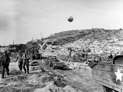 US Army vehicles move inland on Omaha Beach during the early days of the invasion