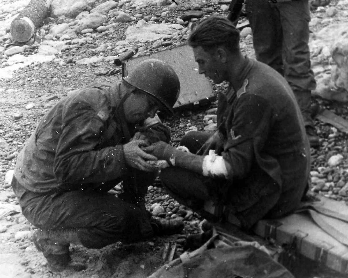 US Medical Officer treats wounded German on Normandy Beach