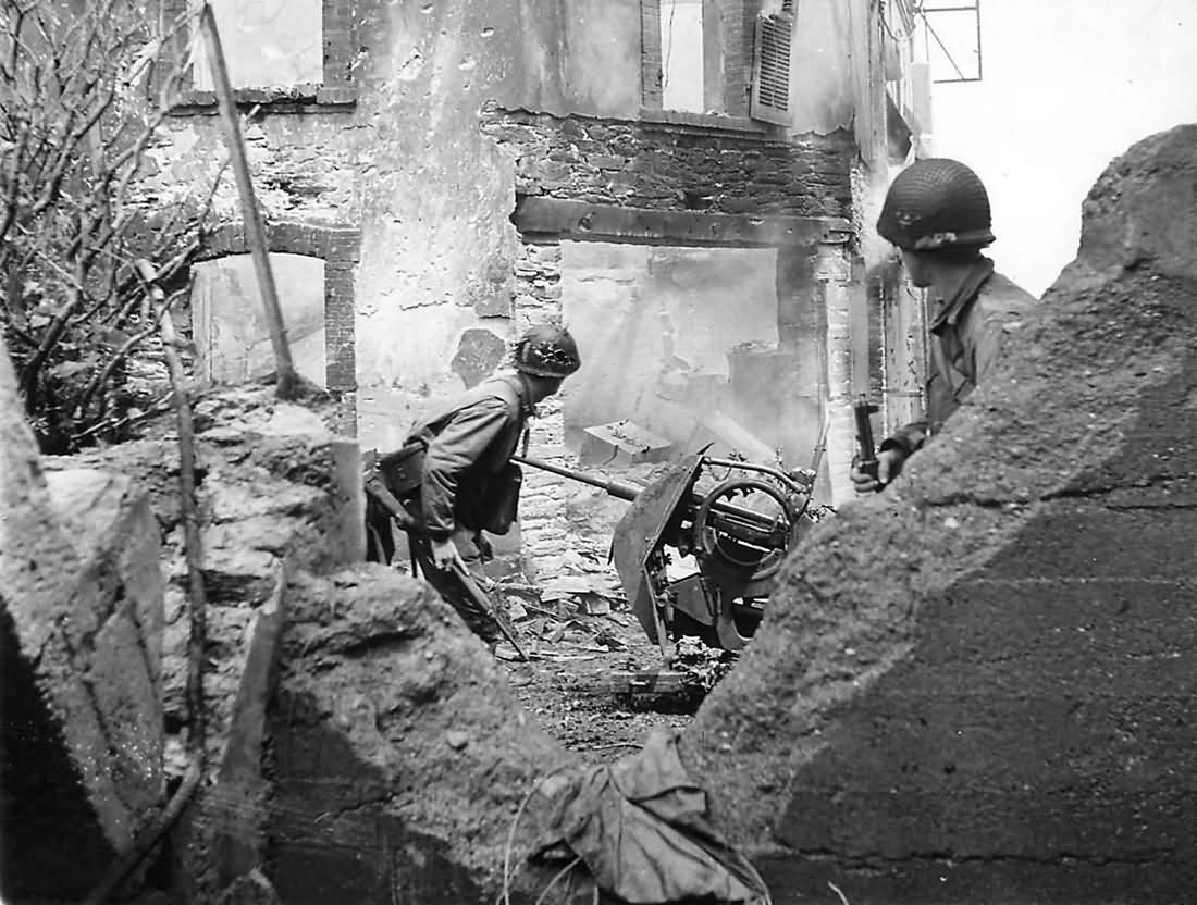 US soldiers hunt for a Germans in a shell torn building in Cherbourg France 1944