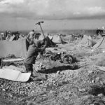 Barrage balloons overhead as US Medics dig in on D-Day beach