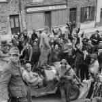 Civilians Cheer US Forces Entering Barneville France June 1944