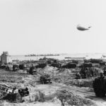US Army trucks move inland from Omaha Beach