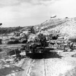 US Army vehicles move inland from a Normandy invasion beach