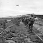 US Infantrymen Advance thru German Minefield in Normandy 1944