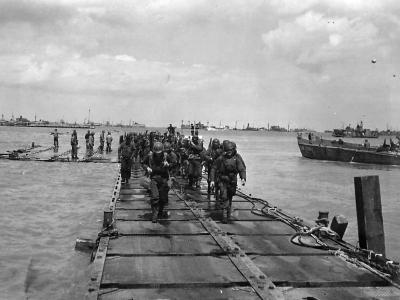 US troops coming ashore on Mulberry A on D-Days Omaha Beach at Saint Laurent Sur Mer