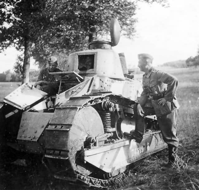 Two German soldiers posing with a light tank FT-17 74519, 1940