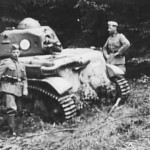 German troops pose next to a captured and damaged Renault R-35 tank