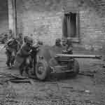 US 3rd Army Troops Roll 57mm Gun through the streets of Town on Saar Front 1944