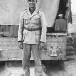 Wehrmacht Afrika Korps soldier with EKII Ribbon by Truck in Desert