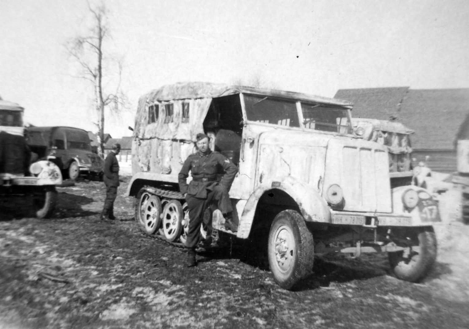 Wehrmacht soldiers standing next to a SdKfz 6