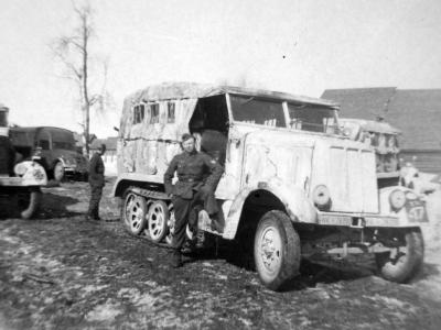 Wehrmacht soldiers standing next to a SdKfz 6
