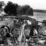 German troops use Sd Kfz 7 to tow Flak 18 gun up a hill