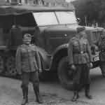 Wehrmacht soldiers posing beside a SdKfz 7 halftrack