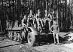 Wehrmacht soldiers next to a SdKfz 7 halftrack