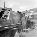 Cpl Sid Walker of the County of London Yeomanry, 7th Armoured Division next to a Jagdpanther – Gheel 16 September 1944
