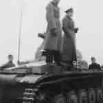 Two German officers atop a Panzer II tank