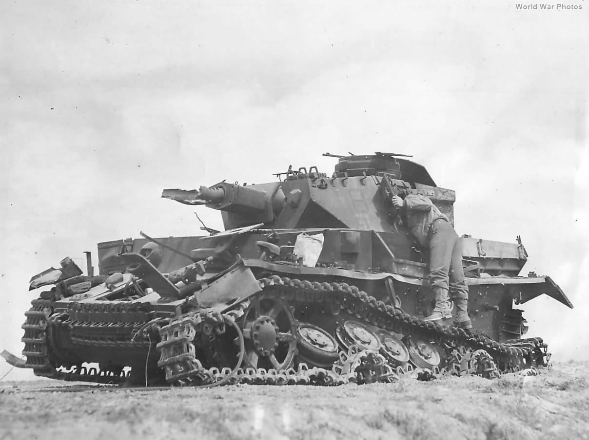 US soldier pokes his head inside a knocked out tank near Bir Marbott in Tunisia