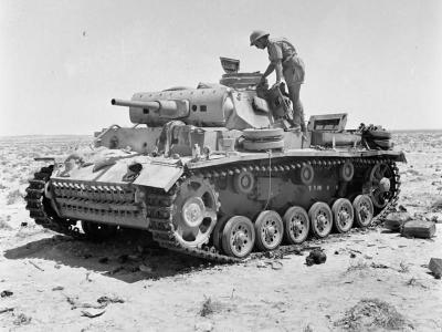 A destroyed Panzer III tank being inspected near Tel el Eissa 4 August 1942
