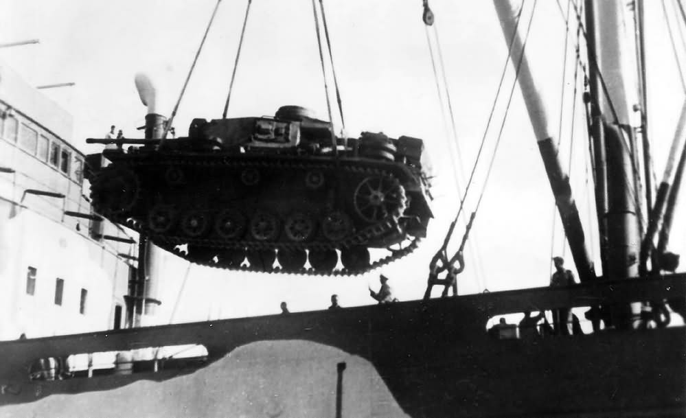 Panzer III tank being loaded into a ship DAK