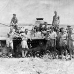British soldier posing beside a Panzer III Africa