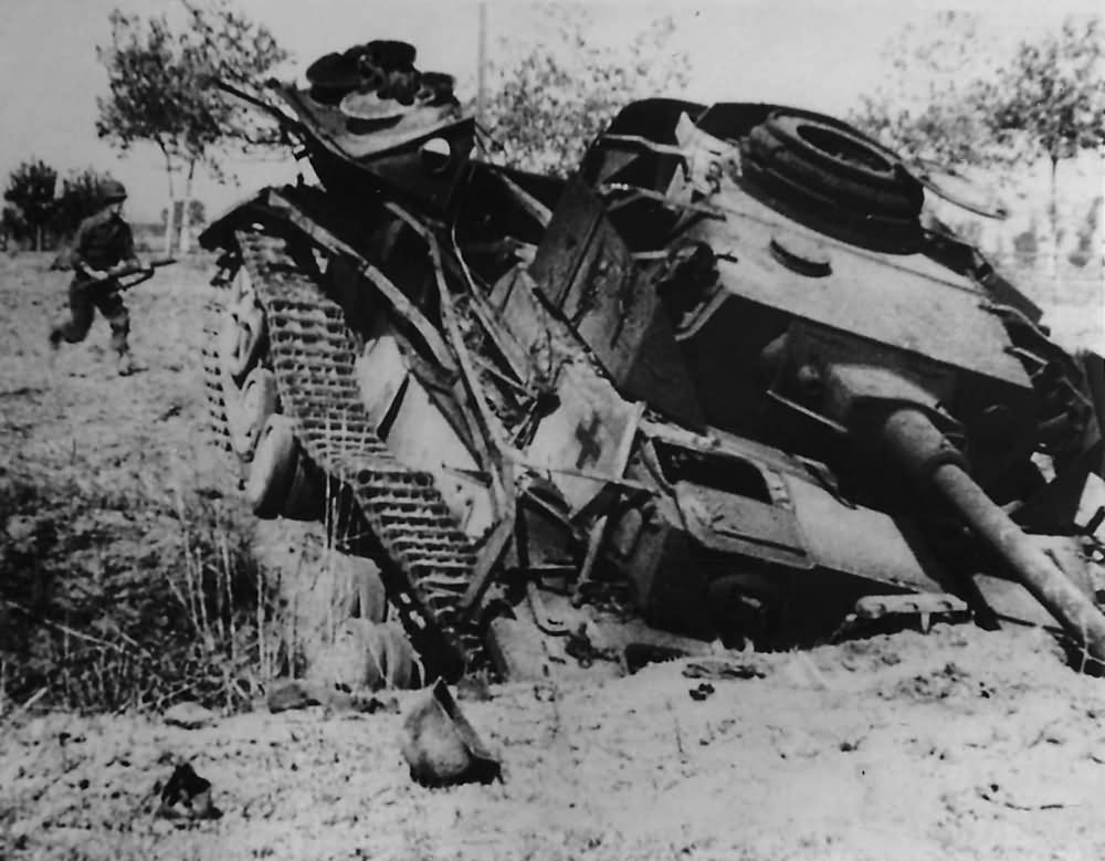 American soldier approaches a knocked out German Panzer IV tank near Salerno