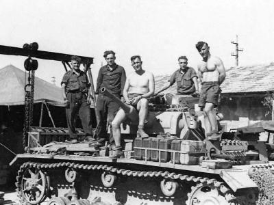 Crew work on a Panzer III tank in a workshop