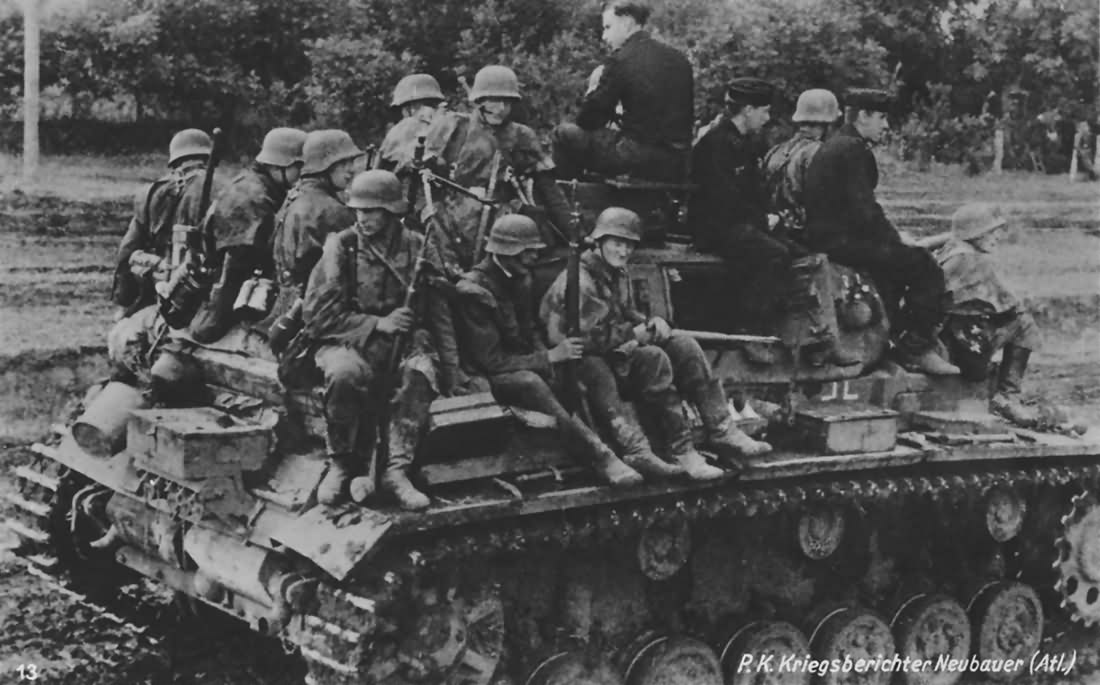 German roops riding on the back of the Panzer III