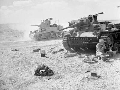 Stuart tank passes by a destroyed German Panzer III November 1942