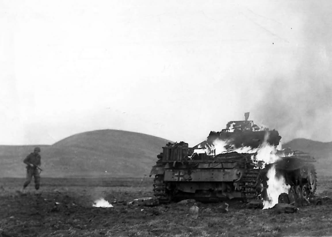 US soldier approaches burning Panzer III at Madjez El Bab 12 January 1943